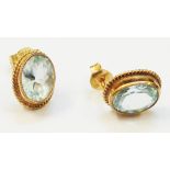 A pair of import marked 375 gold oval panel ear-rings, each set with oval aquamarine