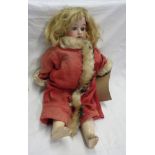 A late 19th Century Armand Marseille bisque headed doll marked 390 1M, with composition body and
