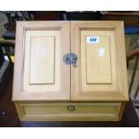 A 13 1/4" reproduction stained mixed wood slope fronted table top stationery cabinet with fold out