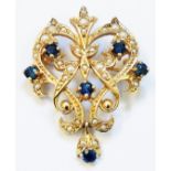 A hallmarked 375 gold Edwardian style open scroll pendant/brooch encrusted with seed pearls and