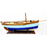 A wooden model of the 1930 Mevagissey Lugger built by Percy Mitchell, often seen moored alongside