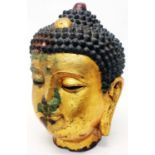 An over sized cast metal Buddha head with gilt and painted finish