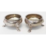 A pair of George II silver salts with remains of gilt interiors, set on triple hoof pattern feet -