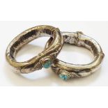 A pair of early 20th Century Bedouin white metal clasp bracelets with applied decoration and oval