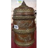 An Oriental copper lidded solak pot with applied dragon and mask decoration