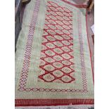 A large vintage Princess Bokhara fringe end wool rug with repeat medallion main within multi borders