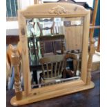 A modern polished pine dressing table mirror with bevelled oblong plate and flanking turned