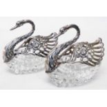 A pair of 4 1/2" import marked 925 silver and cut glass swan pattern condiments with pierced and