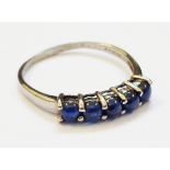 A marked 9k five stone sapphire bead ring