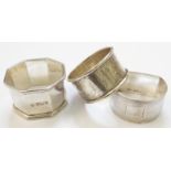 Three silver napkin rings of varying design - one bearing monogram