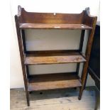 A 22" early 20th Century oak three shelf open bookcase with moulded top and slender square tapered