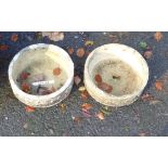 A pair of small concrete garden planters