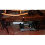 A 4' 5 1/2" Edwardian oak side table with two frieze drawers, set on turned and moulded legs