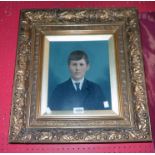 An ornate gilt gesso box framed and slipped overpainted photographic portrait of a boy