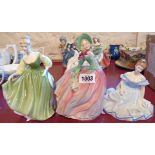 Three Royal Doulton figures comprising Autumn Breezes HN 1911, Fair Lady HN 2193 and Marjorie HN
