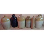 A collection of stoneware jars including three Devon local examples for W.G. Caunter, Exeter