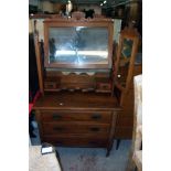 A 36" Edwardian walnut dressing chest with triple mirror, flanking pierced supports, trinket drawers