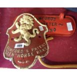 A cast iron tractor seat plaque for Bamford's Patent Lion Horse Rake and a cast iron Bamford's