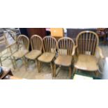 A set of four 20th Century hoop stick back kitchen chairs with moulded solid elm seats, set on