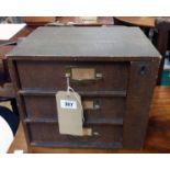 A 12 1/2" vintage bracket locking three drawer table-top file chest with textured paper finish