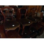 A set of four Victorian mahogany framed scalloped balloon back dining chairs with stylised wheat