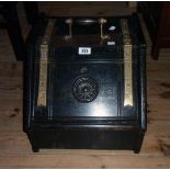 A Victorian stained oak slope fronted coal box with decorative brass hinges, roundel to lid and