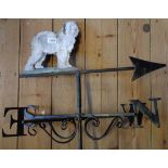 A metal weather vane with sheepdog decoration