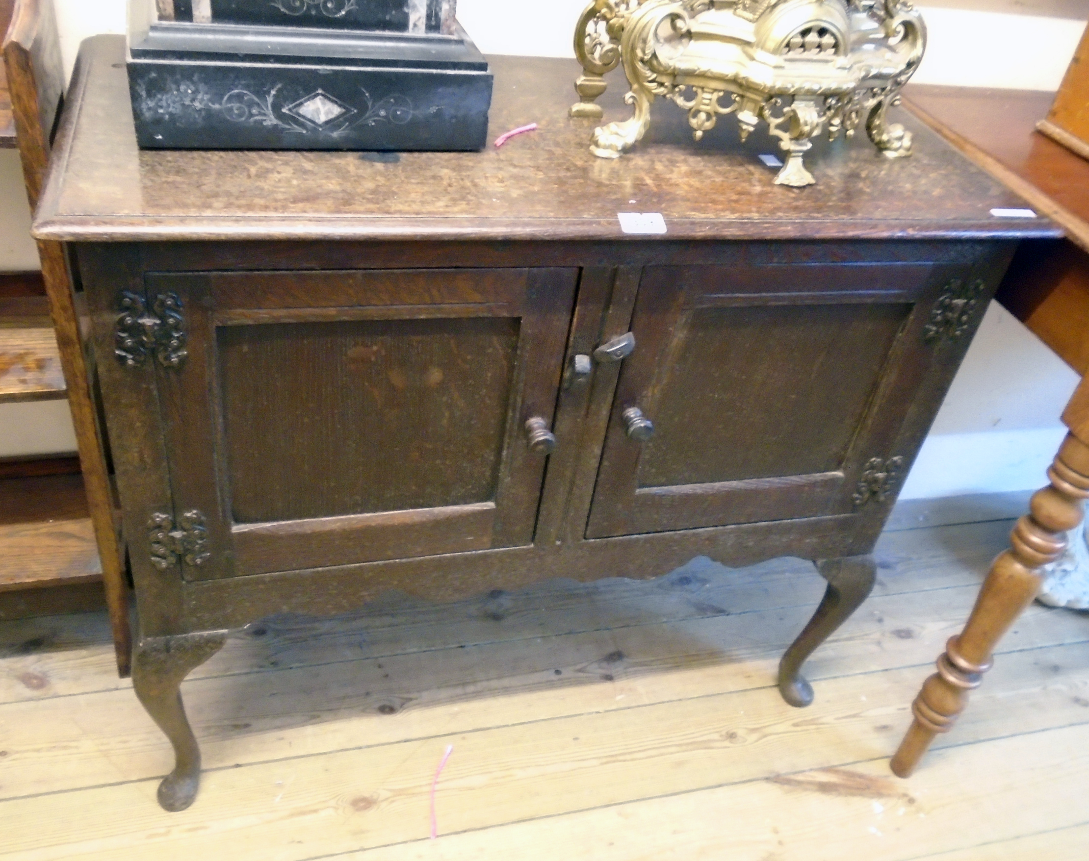A 36" 20th Century polished oak two door dresser base, set on cabriole front legs with pad feet