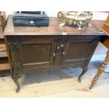 A 36" 20th Century polished oak two door dresser base, set on cabriole front legs with pad feet