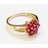 A marked 14k ruby flowerhead ring