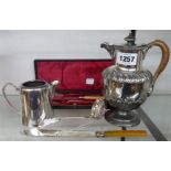 An antique pedestal hot water jug, sifter spoon - sold with a cased harlequin knife, fork and