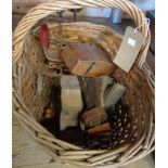 A wicker basket containing vintage tools
