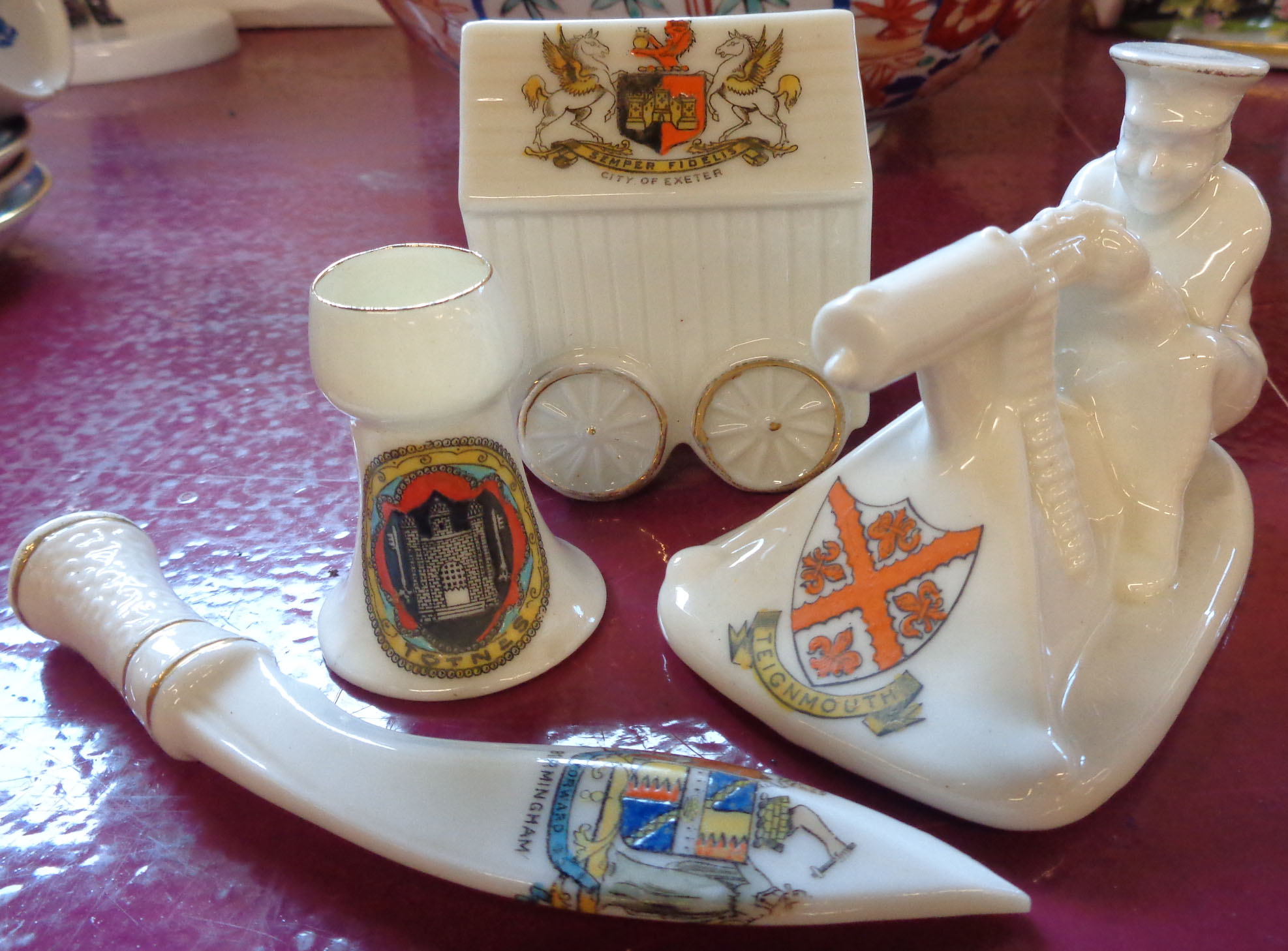 Four pieces of Goss style crested ware including Arcadian First World War machine gunner, kukri,