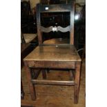 A 19th Century oak hall chair with solid seat panel and square supports