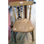 An antique child's stick back standard chair with moulded solid elm seat, set on simple turned
