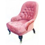 A Victorian child's tub chair with old rose button back upholstery, set on turned front legs and