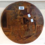 A circular marquetry plaque depicting a Tudor courting scene