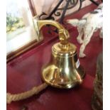 A wall mounted brass bell