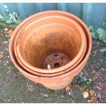 Three large terracotta plant pots