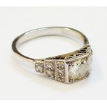A 1930`s Art Deco marked "PLAT" ring, set with central 0.5ct. diamond and further diamonds to