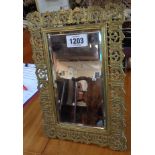 A heavy gauge brass framed easel mirror with pierced decoration