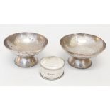 A pair of Eastern soft white metal pedestal bon-bon dishes with pricket writing - sold with a silver