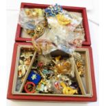 A red jewellery box containing a quantity of assorted good quality costume jewellery