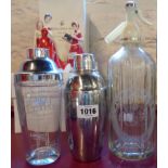 A vintage El-Bart Dry Gin cocktail shaker, another and a Schweppes soda syphon