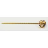A marked 15ct. stick pin, set with small sapphire and seed pearls
