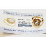 A marked 375 gold ring, set with central glacier topaz within a citrine border