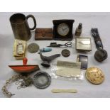 A box containing a quantity of collectable items including travelling clock, enamelled silver needle