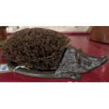 A cast iron hedgehog pattern boot scraper