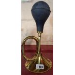 A reproduction brass car horn