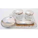 A harlequin dressing table set with silver topped jar, hair tidy, silver backed hand mirror and